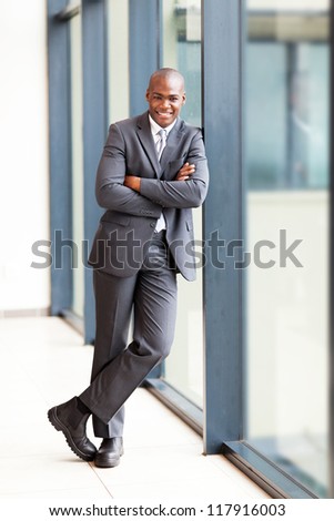 young african american businessman full length portrait in office