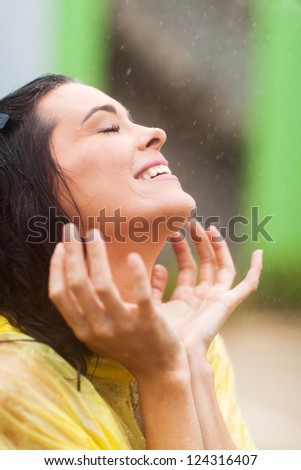 happy young woman having fun in the rain