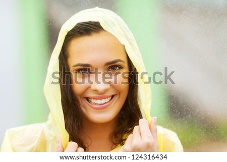 beautiful woman dress in raincoat in the rain