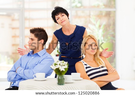 middle aged mother feeling helpless when caught in between young couple\'s fight