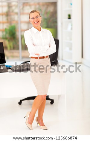 senior businesswoman full length portrait in office