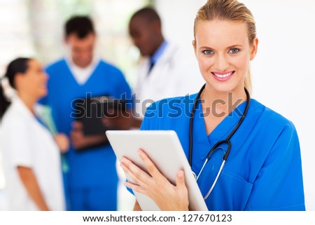 pretty medical nurse with tablet computer in hospital