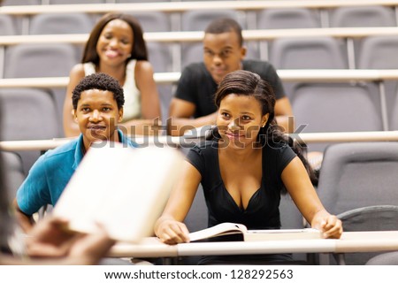 college professor lecturing group of african students in classroom