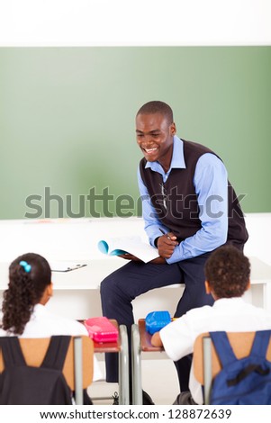 male african primary school teacher teaching in classroom