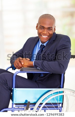 optimistic handicapped african businessman sitting on wheelchair