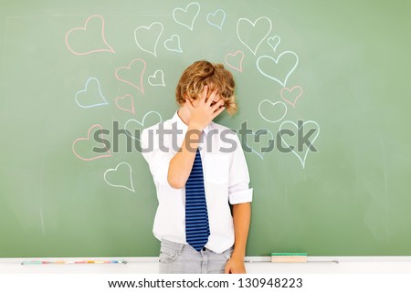 young teenage boy hide face because of love