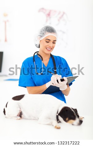 female veterinarian writing report after dog examination