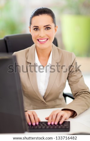 portrait of female secretary in office typing