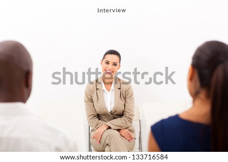 caucasian woman during employment interview with two human resources personnel