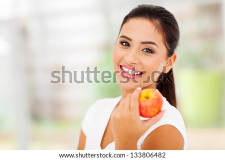 portrait of pretty woman with an apple close up