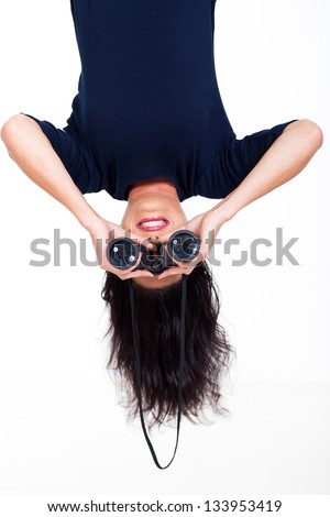 upside down photo of young woman holding binoculars
