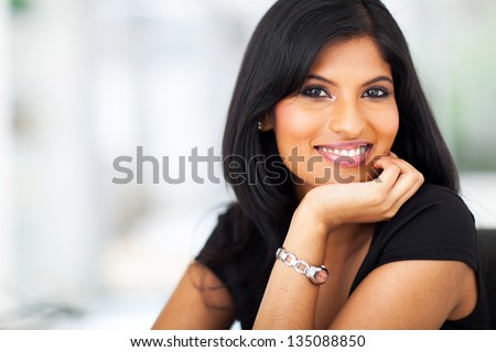 close up portrait of indian smiling businesswoman in office