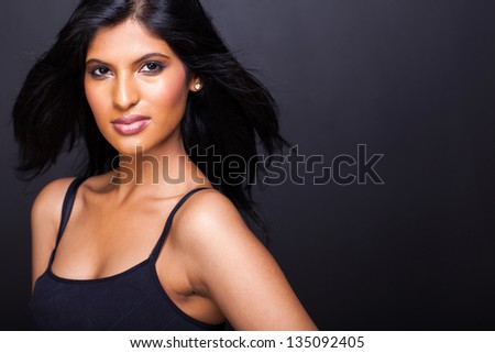 portrait of young sexy young hispanic woman posing on black background