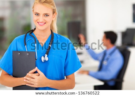 portrait of beautiful young nurse with stethoscope in doctors office