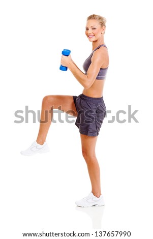 fit woman exercising using dumbbells with one leg up