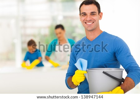 happy family man cleaning home with his family