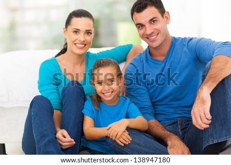 lovely young family of three sitting at home