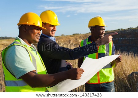 mine manager and workers at quarry discussing future plan