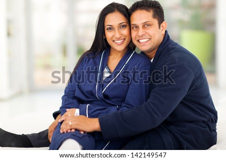 beautiful loving indian couple sitting in bedroom