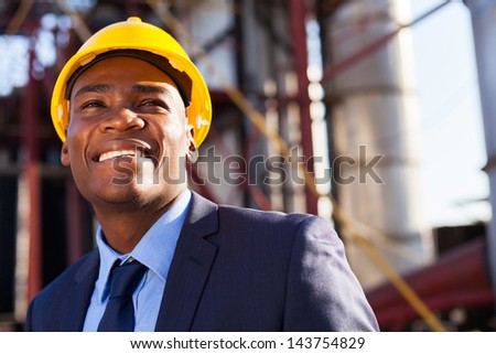 happy african industrial manager at oil refinery plant