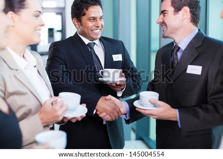 friendly business people interacting during conference break