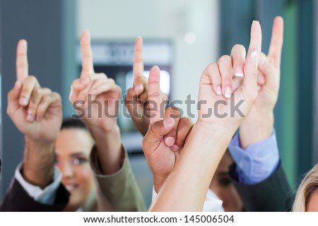 multiracial business group raising hands