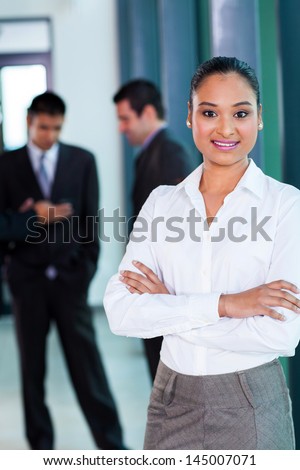 happy young indian businesswoman in modern office