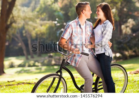 lovely happy teenage couple hugging outdoors