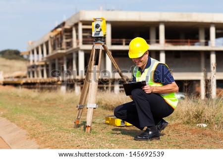 middle aged land surveyor working outdoors