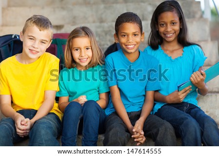 group of smiling primary school students outdoors
