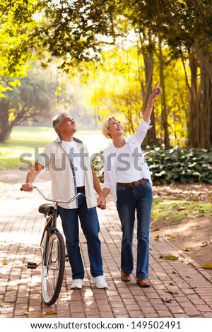 happy middle aged couple enjoying being outdoors