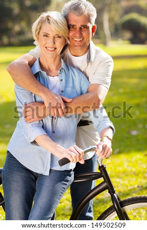 beautiful middle aged couple on bike outdoors