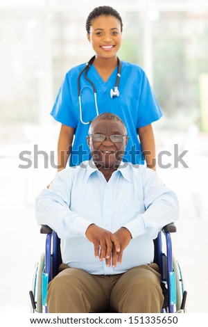 pretty african health care worker and disabled senior patient
