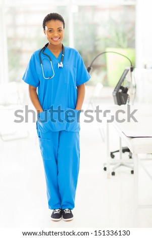 portrait of attractive young african nurse standing in modern office