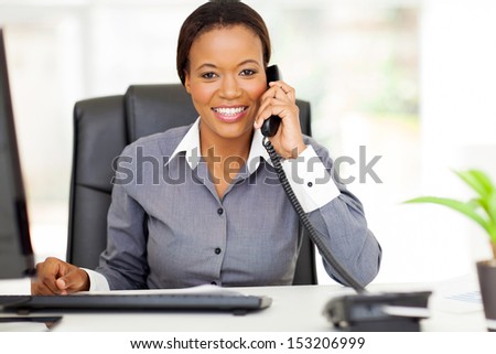 portrait beautiful african american businesswoman using landline phone