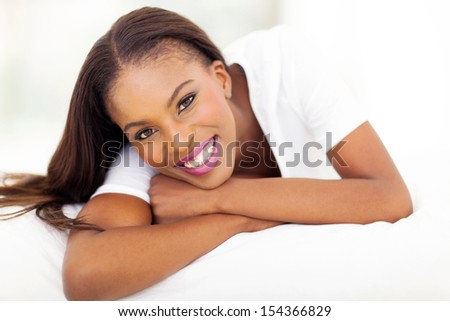 beautiful african american woman lying on bed