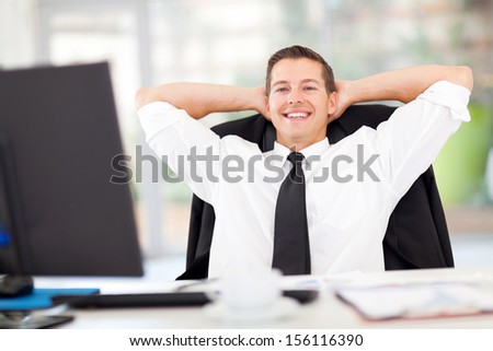 portrait of young businessman relaxed in office