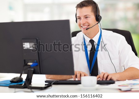 handsome technical support operator working on computer