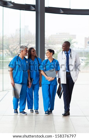 group of successful medical doctors walking in hospital