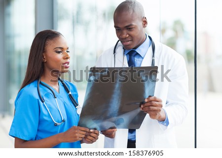 successful african american medical workers studying patient\'s x-ray