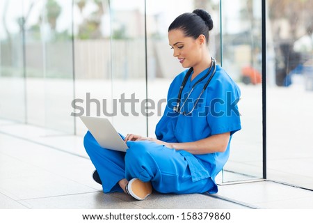 beautiful medical nurse working on laptop
