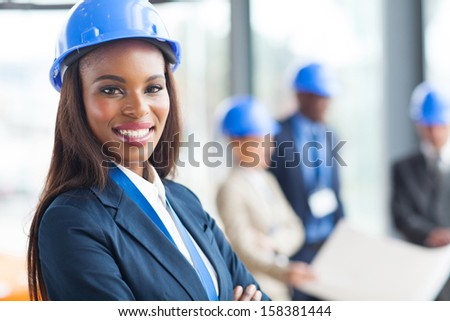 pretty african american female construction worker in office