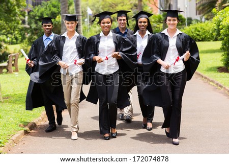 group of cute multiracial graduates walking on college campus