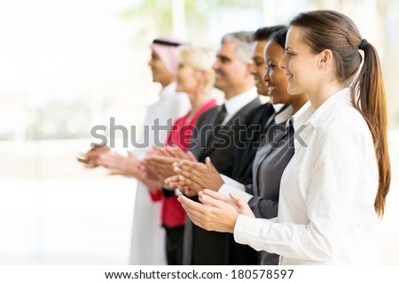 group of multicultural business partners applauding