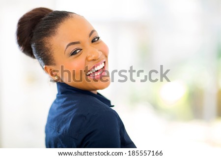 cheerful young african american businesswoman looking back