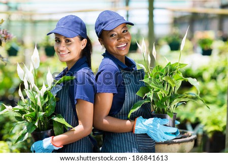 two happy gardeners portrait in greenhouse