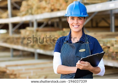 beautiful female industrial worker holding clipboard