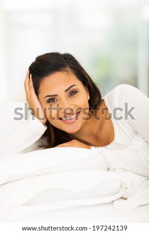 pretty woman lying in cozy bed relaxing