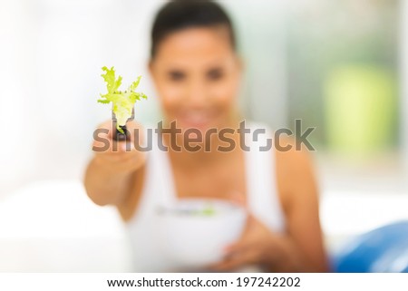 close up of woman giving fresh green salad