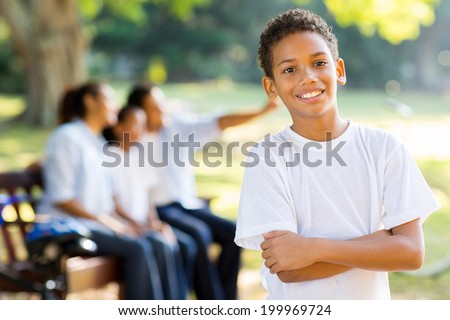 happy little indian boy in front of family outdoors